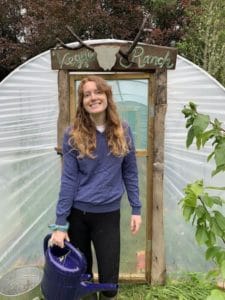 Stef-watering-the-tomatoes-in-the-poly-tunnel